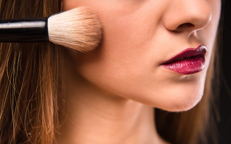 Portrait of a young beautiful woman with long hair, isolated on black background