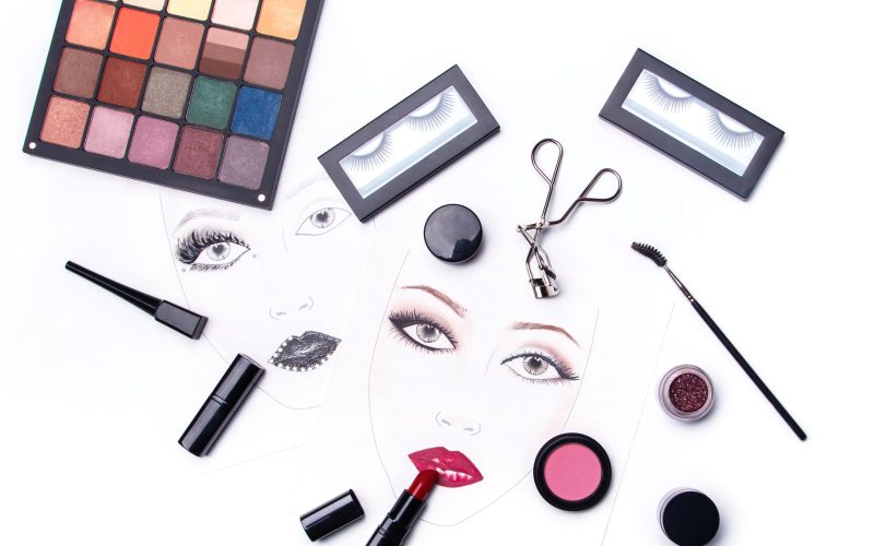Face charts and different makeup objects and cosmetics on white background